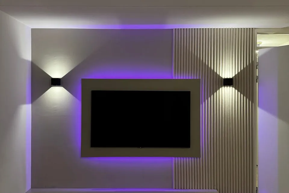 Tv-wand met verticale lamellen, een verzonken televisiescherm, wandlampen en indirecte led-verlichting
